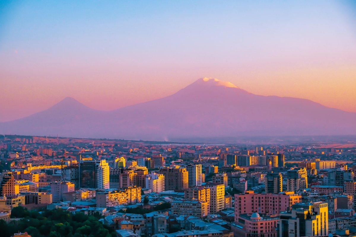 Yerevan spread across the city at sunset with snow-capped Mount Ararat rising behind the skyline