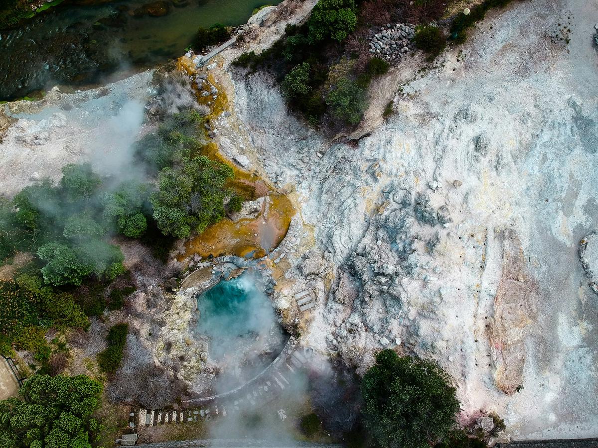 Aerial view of the Furnas geothermal landscape on São Miguel, with steaming ground beside water