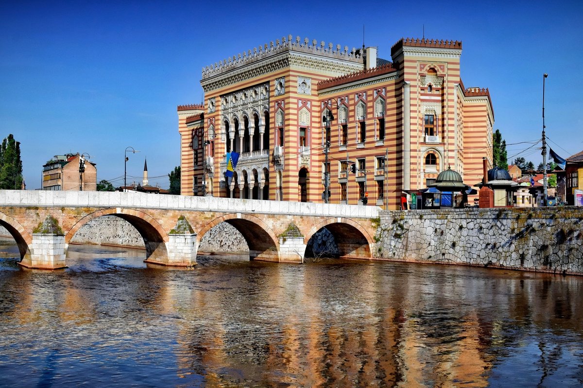 Vijećnica, Sarajevo City Hall, with its patterned neo-Moorish façade beside the Miljacka River