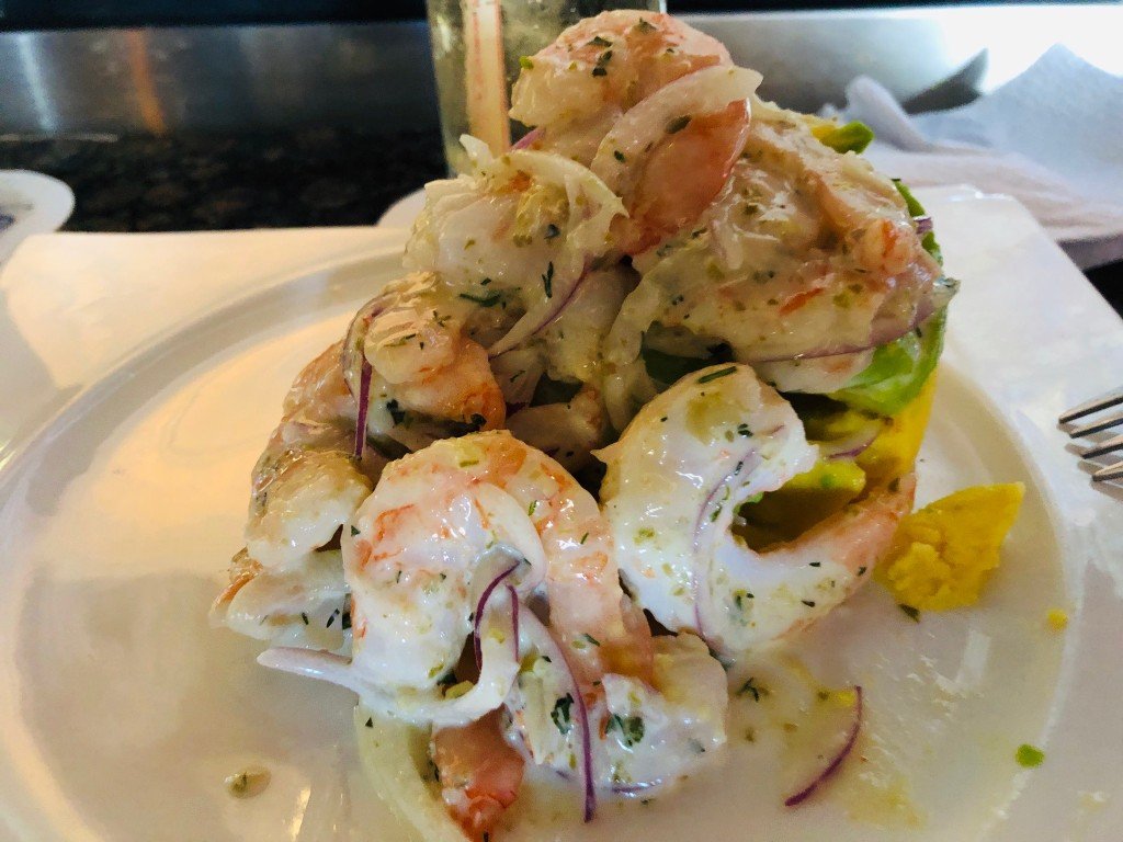 A mound of shrimp ceviche with red onion on a white plate at Cuzco Cocina Peruana in Cartagena