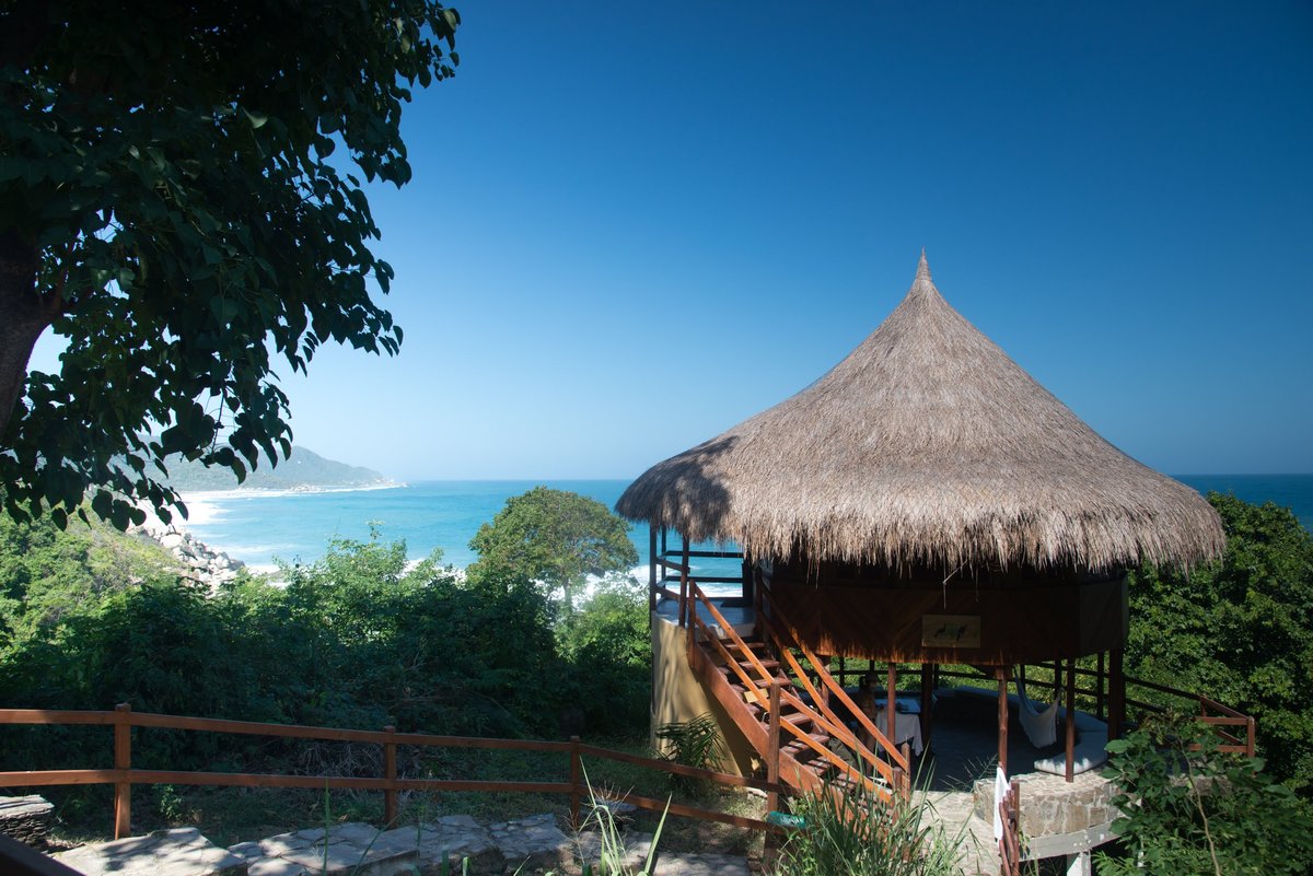 A thatched hut on the rocks above the turquoise Caribbean at Cabo San Juan, Tayrona National Park, Colombia