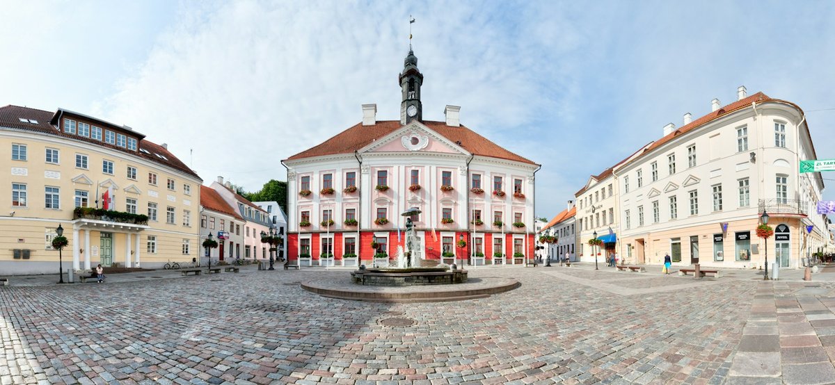 Tartu Town Hall Square with the pink Town Hall, cobblestones and the Kissing Students fountain