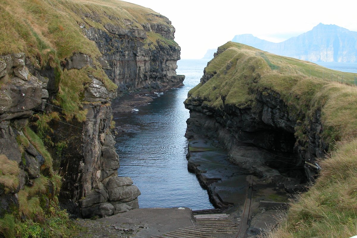 The natural sea-filled gorge at Gjógv, a cleft in the coastal rock used as a harbour