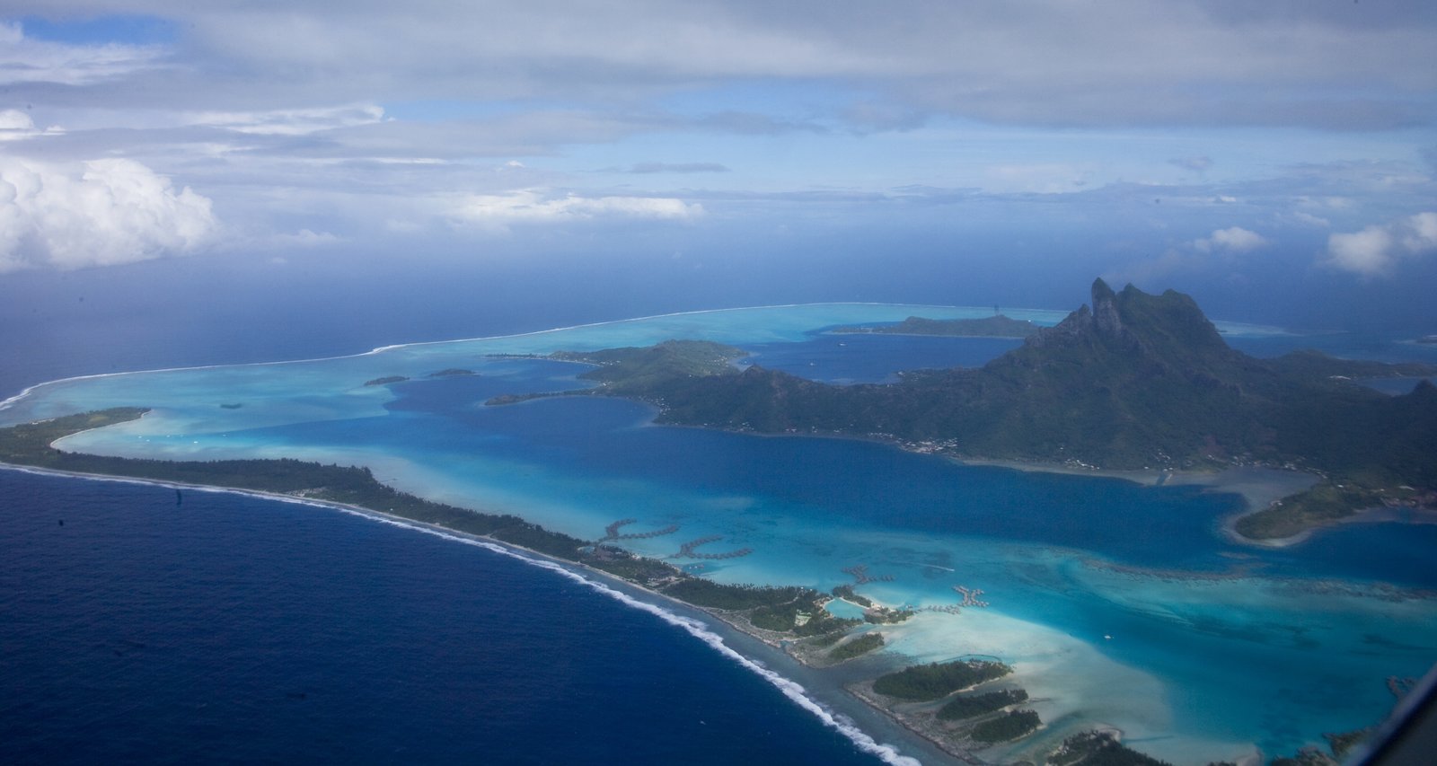 Aerial view of Bora Bora’s turquoise lagoon, reef islets and Mount Otemanu rising from the main island