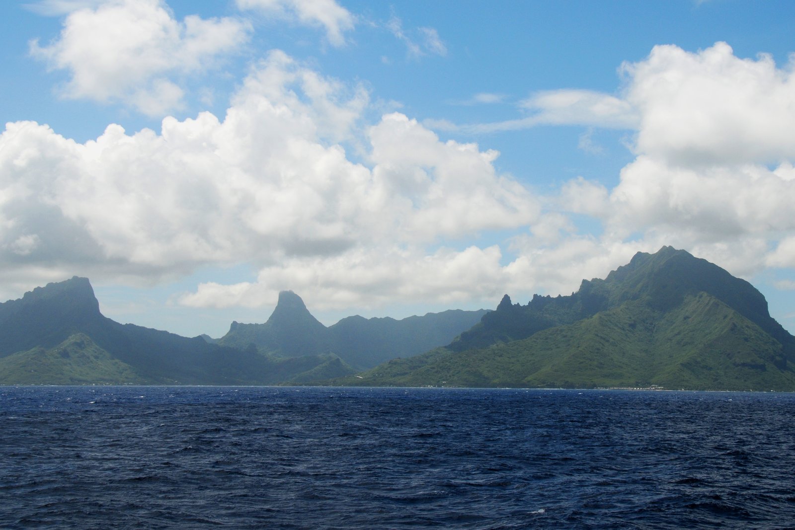 Reef entrance and turquoise water at Cook’s Bay on Moorea, with green mountains rising behind the lagoon