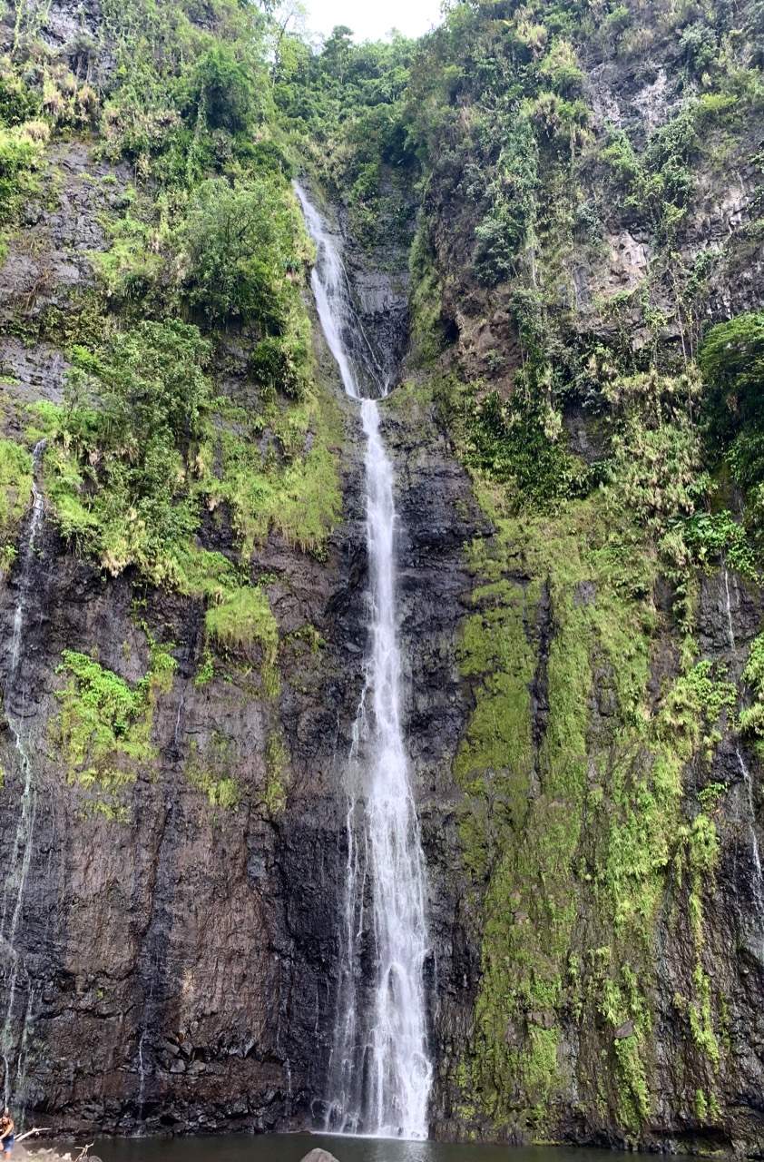 Cascade Faarumai waterfall tumbling through lush green forest near Tiarei on Tahiti