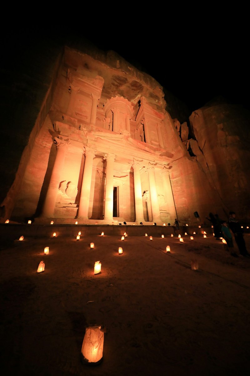The Treasury at Petra lit by candles and warm light during a night visit