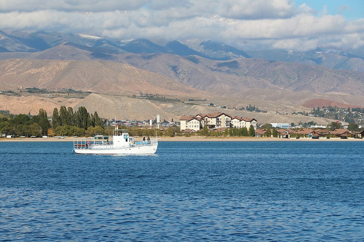 Broad blue surface of Issyk-Kul Lake with surrounding mountain landscape in Kyrgyzstan