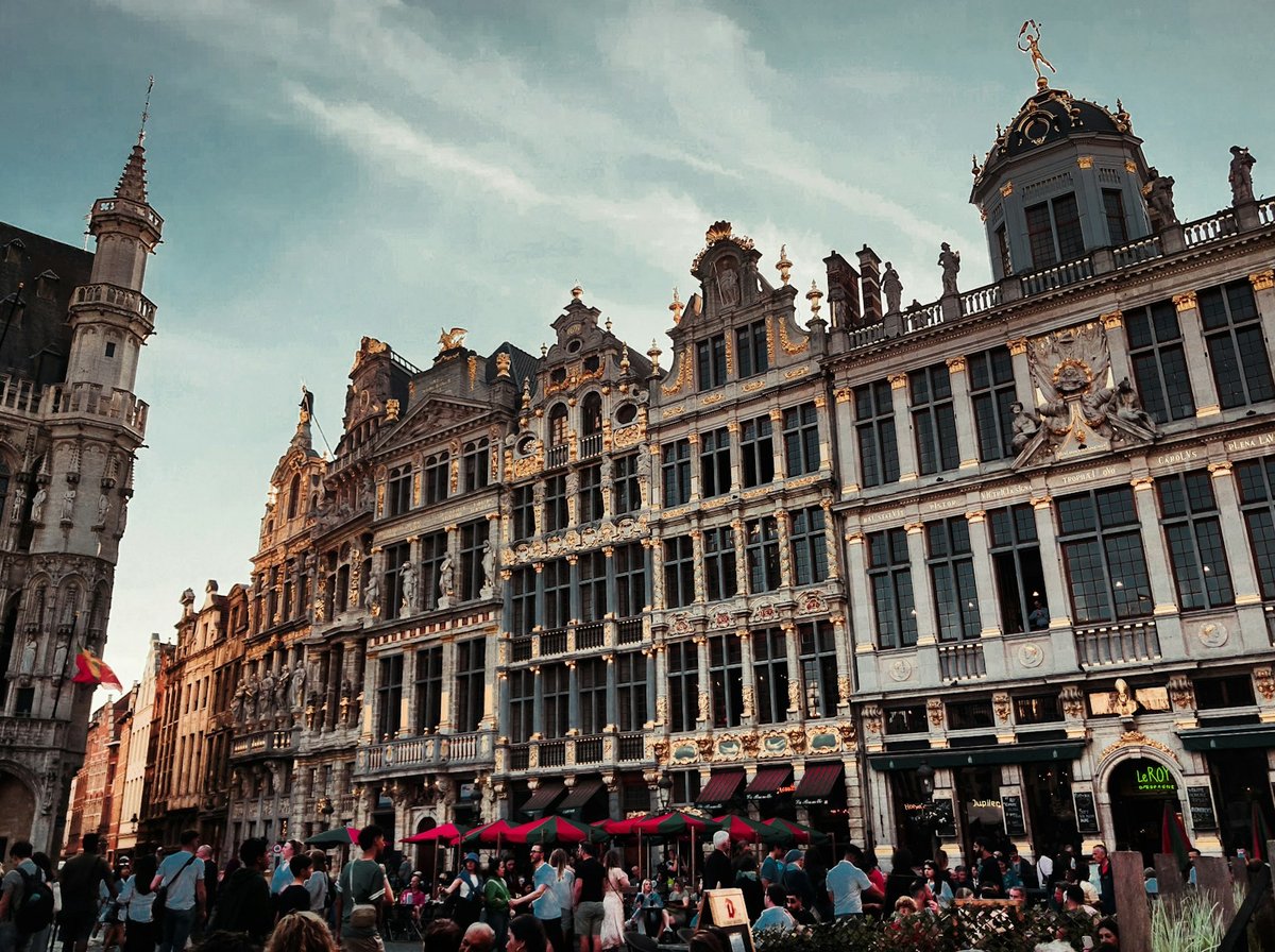Guild houses on Brussels Grand Place, with café terraces and people on the square