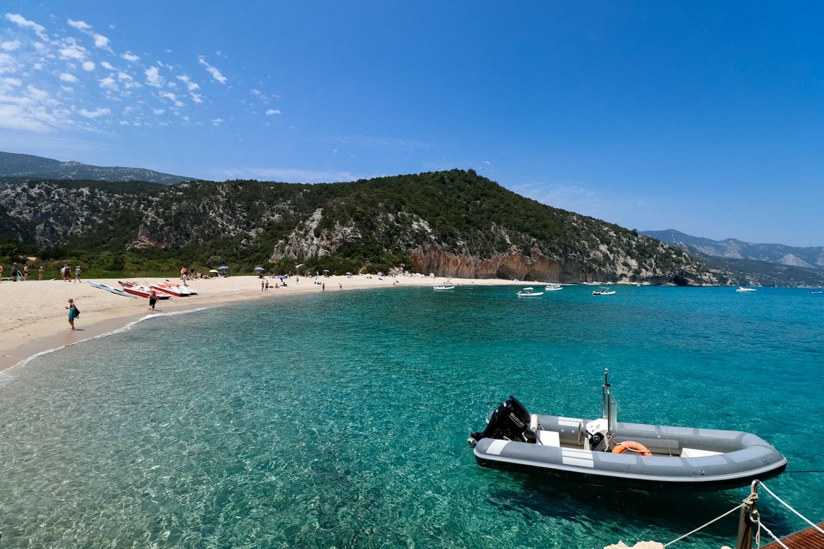 Cala Luna beach with clear water, pale sand and limestone cliffs on the Gulf of Orosei, Sardinia