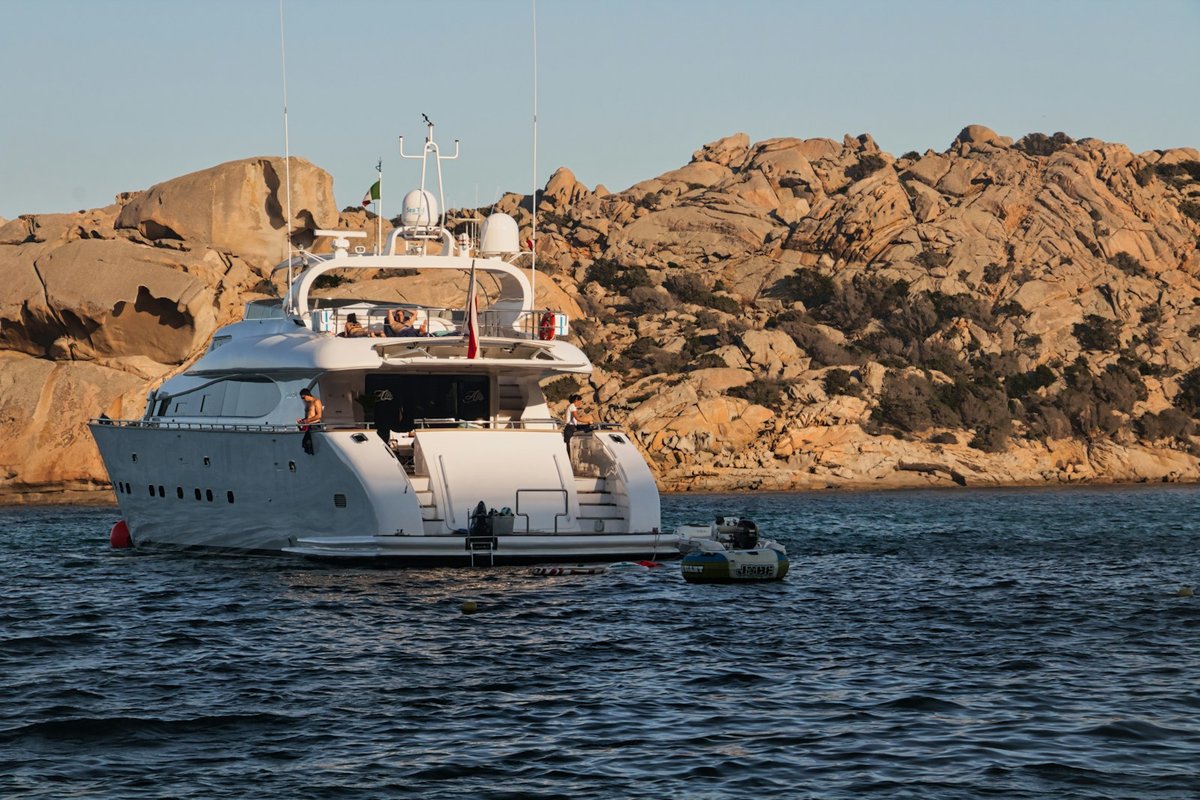 Clear Mediterranean water, rocky coastline and boats around the La Maddalena archipelago in northern Sardinia