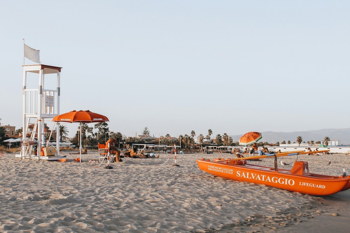 Poetto Beach’s long sandy shoreline near Cagliari, Sardinia, with people on the sand and Mediterranean water