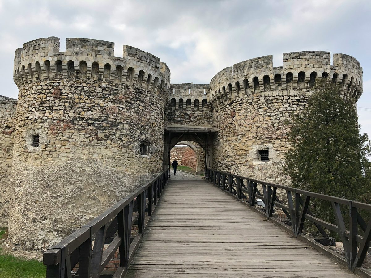 Stone walls of Belgrade Fortress at Kalemegdan, with trees and historic masonry above the confluence of the Sava and Danube