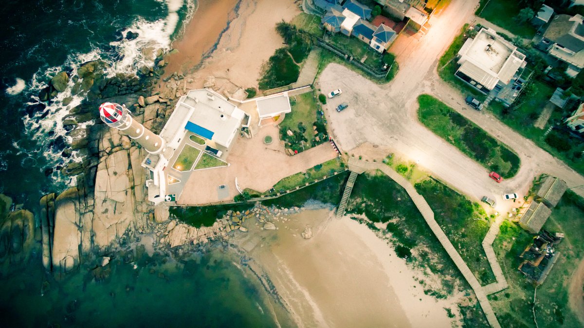Aerial view of the José Ignacio lighthouse on a sandy point between ocean and lagoon